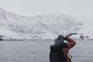 Person staring at a lake and a glacier